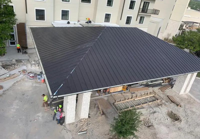 Metal roofing installation team working on a commercial building in Algonquin